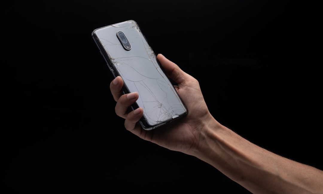 a-person-holding-a-cell-phone-in-their-hand-c5qxlzulx7a
